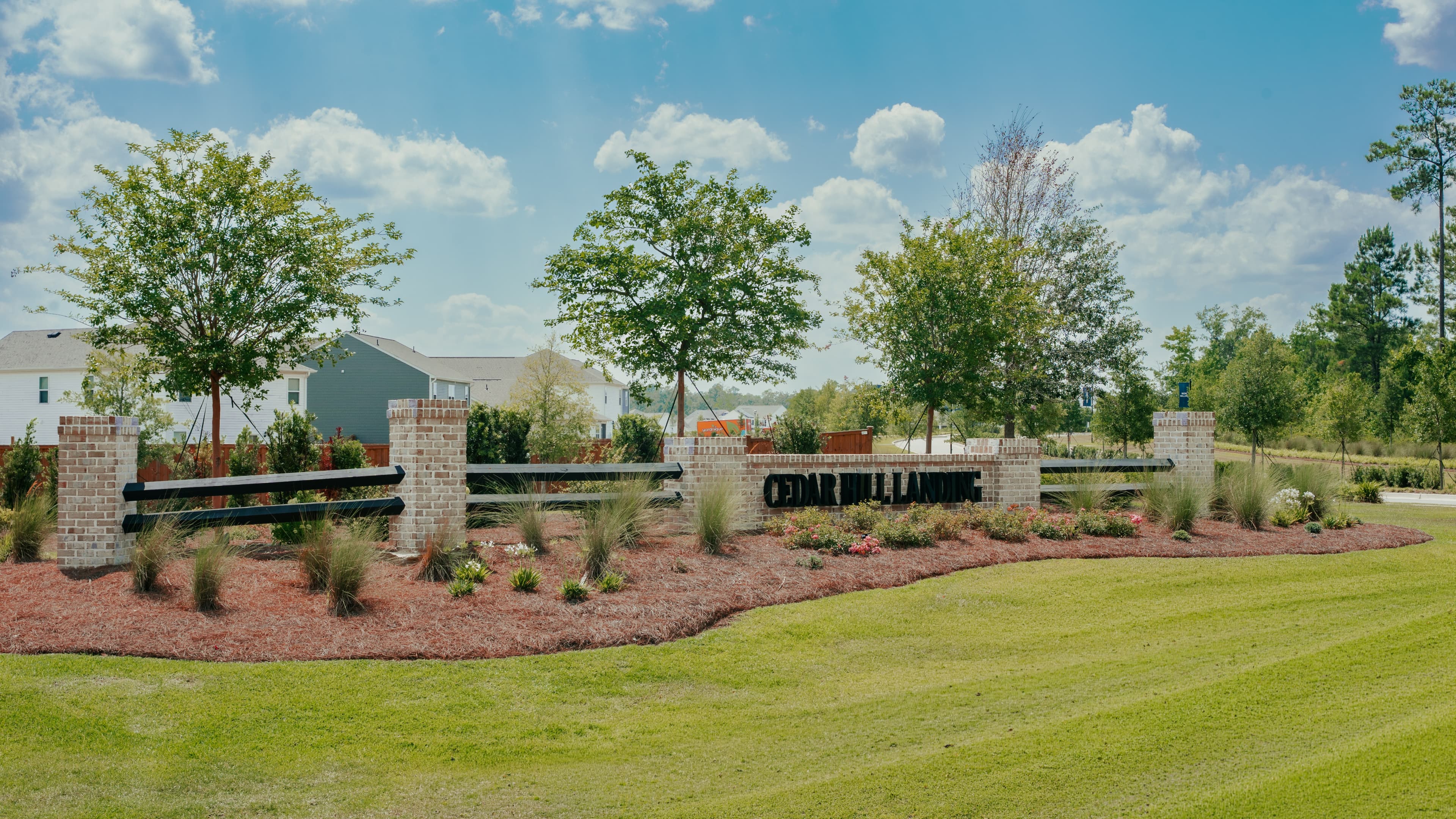 The entrance sign and landscaped beds at Cedar Hill Landing.