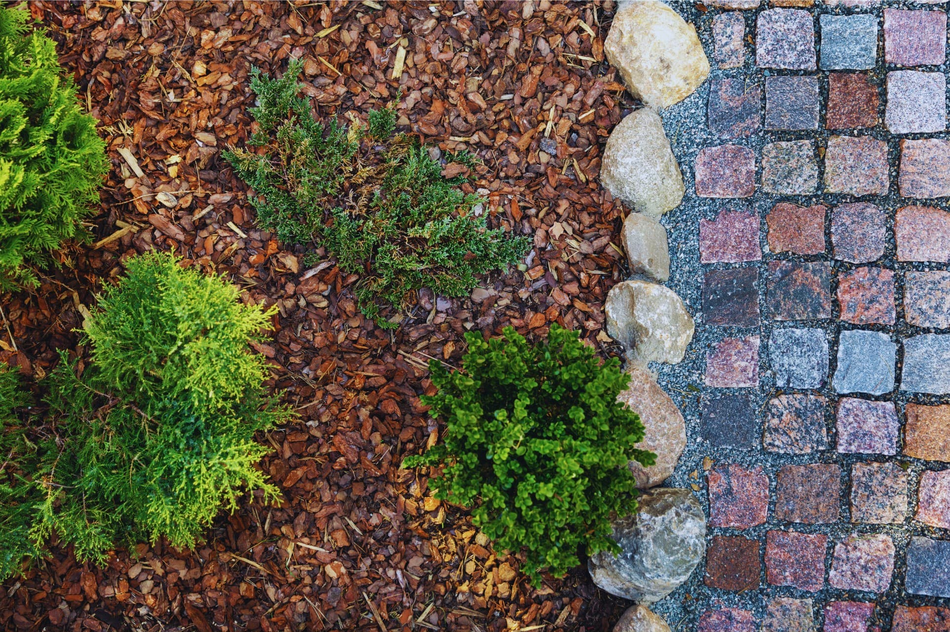 Bagged mulch and bulk stone and gravel on display at the nursery.